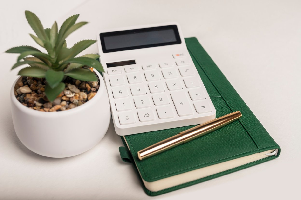 Calculator on green notepad or planner